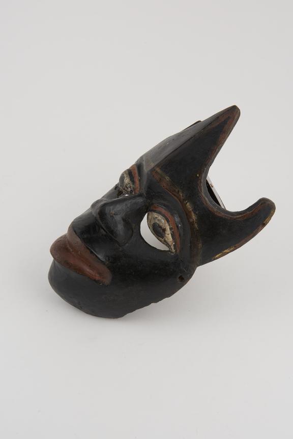 Painted wooden mask, black with red and white detail