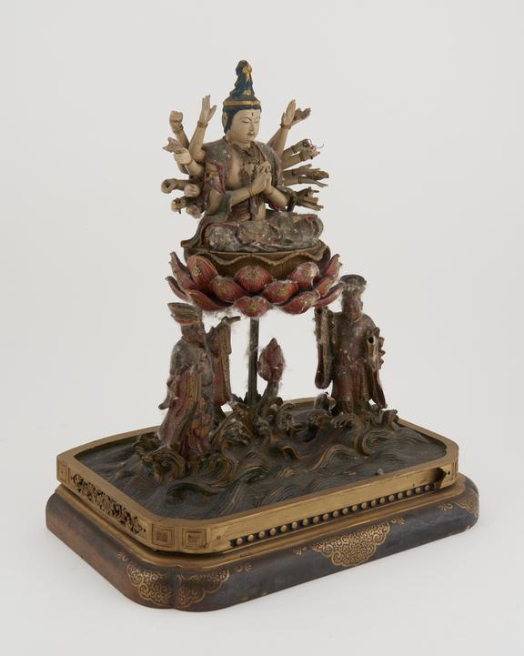 Carved wooden deity with 9 pairs of arms