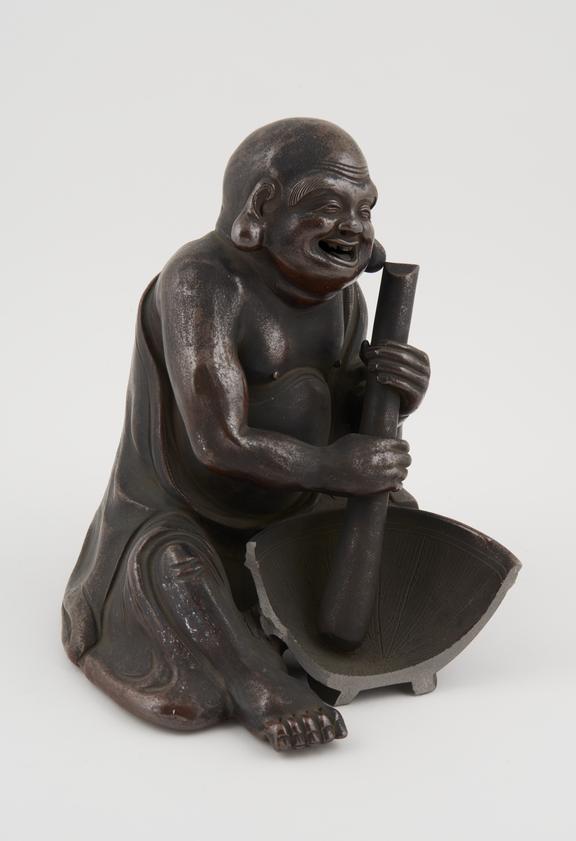 Pottery figure depicting corpulent male with pendulous and