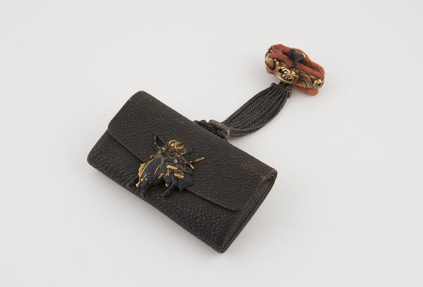 Tobacco pouch which is joined to a netsuke via a bunch of small