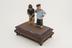 2 wooden figures depicting man smoking tobacco water-pipe and