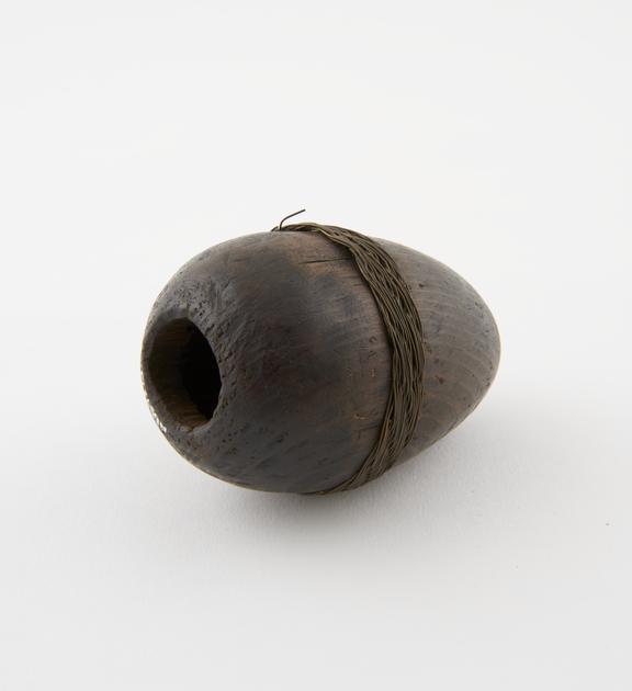 Carved wooden penis sheath, egg-shaped