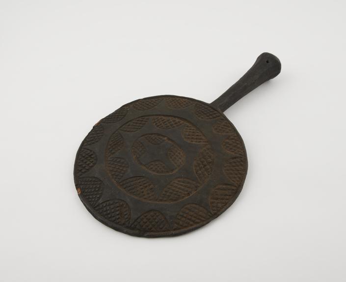 Wooden fan called a Nku Abia', circular with flaked handle