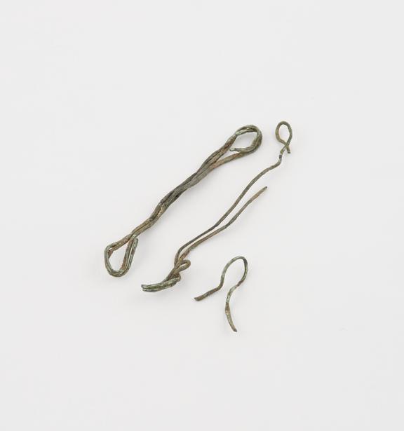 Two copper wire amulets, pieces of wire bent double and twisted