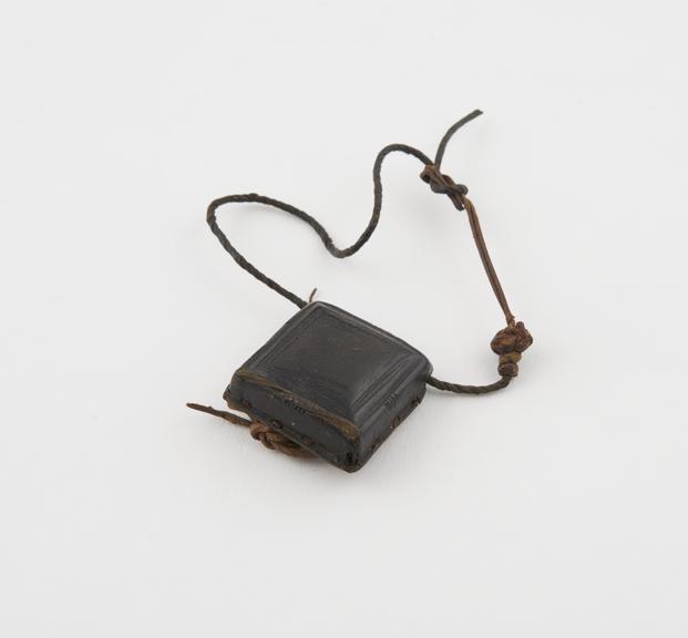 Leather amulet case, square, convexed top, manuscript