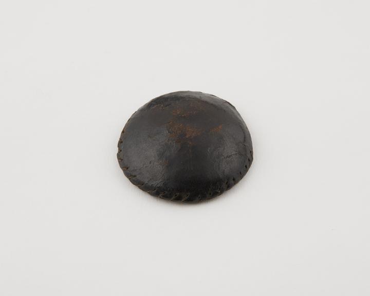 Leather covered, button shaped amulet, Sarakolle, Senegal