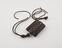 Amulet of leather with decorative panel of woven leather and