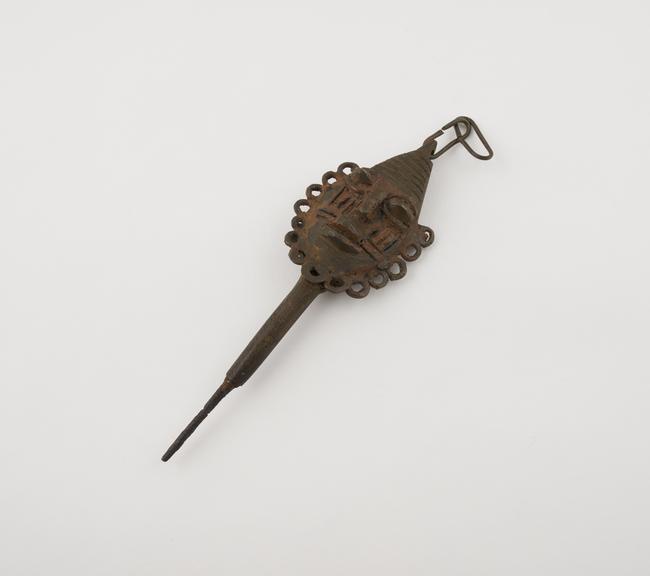 One metal edan head on iron spike with chain links attached to