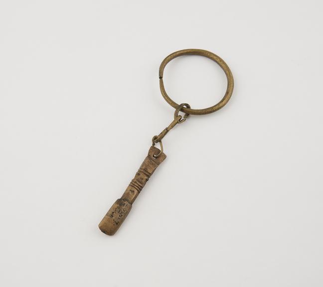 Brass amuletic pendant attached to ring by chain links, Ashanti