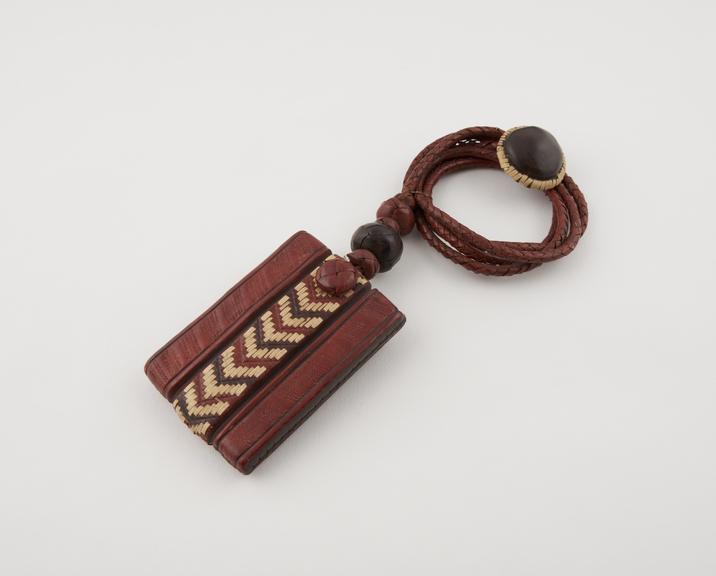 Necklace consisting of leather amulet hung on plaited leather