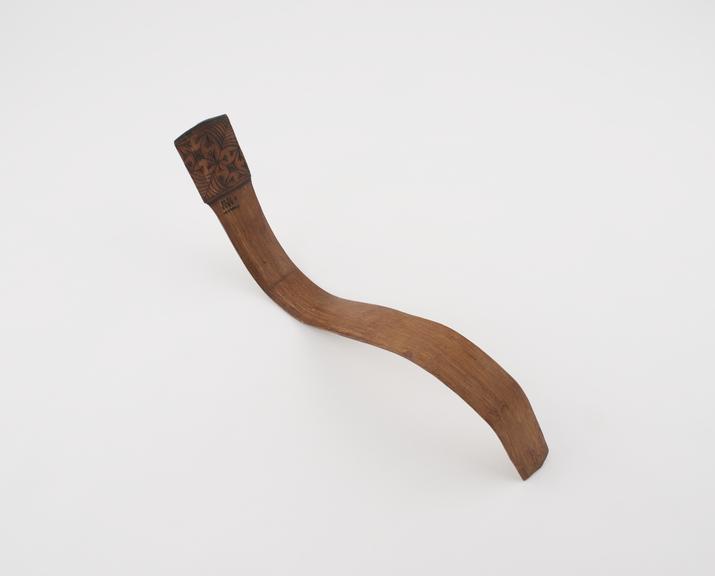 Wooden S-shaped strigil with poker-work design