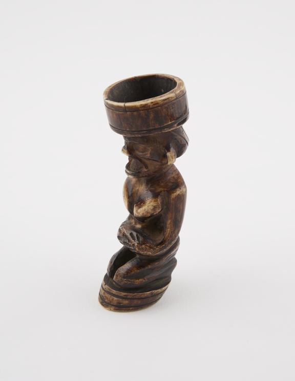 Carved ivory tobacco mortar in the form of a man(?) kneeling