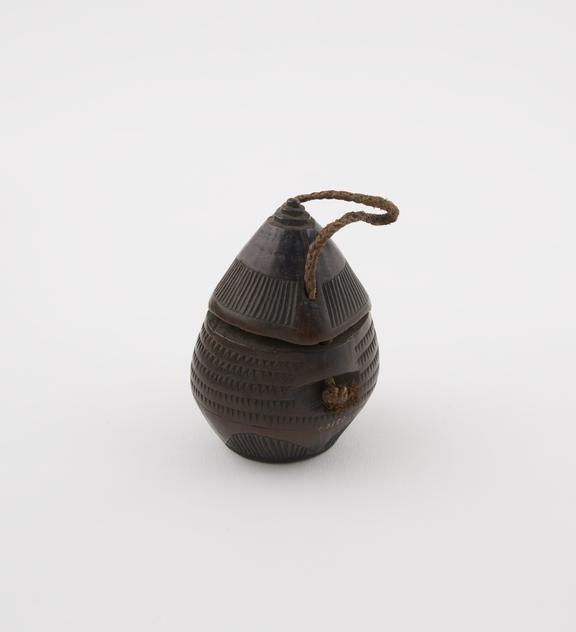 Carved wooden snuff box, barrel-shaped, with conical cap