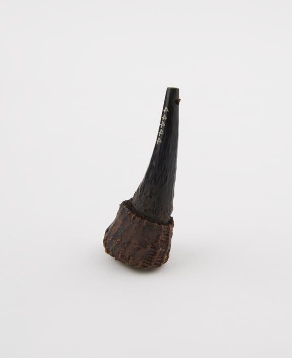 Amulet of horn tip with woven fibre covering wide end