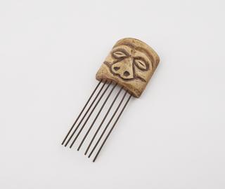 Comb with carved ivory handle in form of human face
