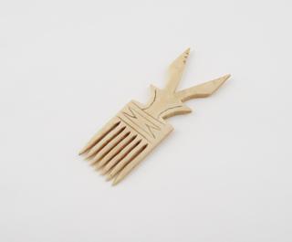 Ivory comb with seven teeth and V-shaped handle