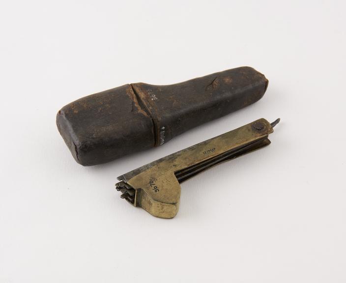 Seven bladed fleam, with knife, steel blades in brass case