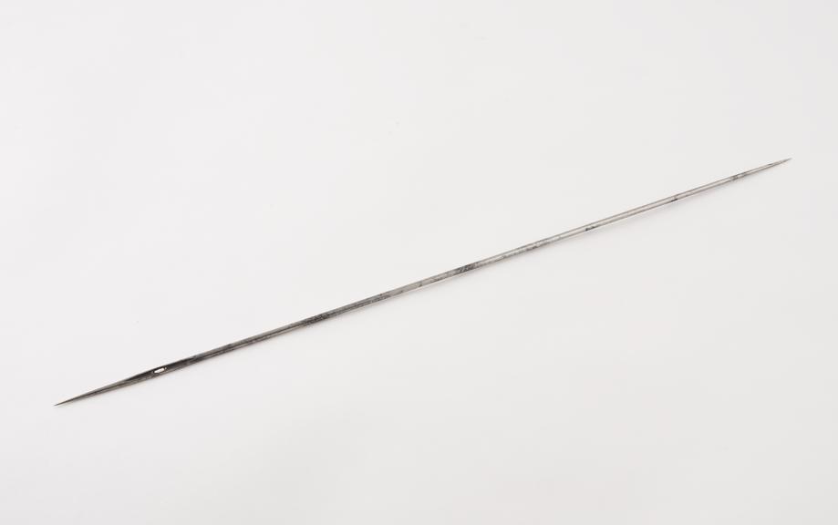 Large needle, straight, eyed, pointed at both ends, steel