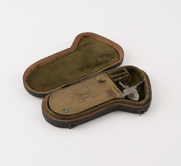 Large brass automatic lancet, in fish skin case, by Pepys