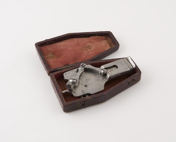 Steel automatic fleam, in leather covered case, by W. and H