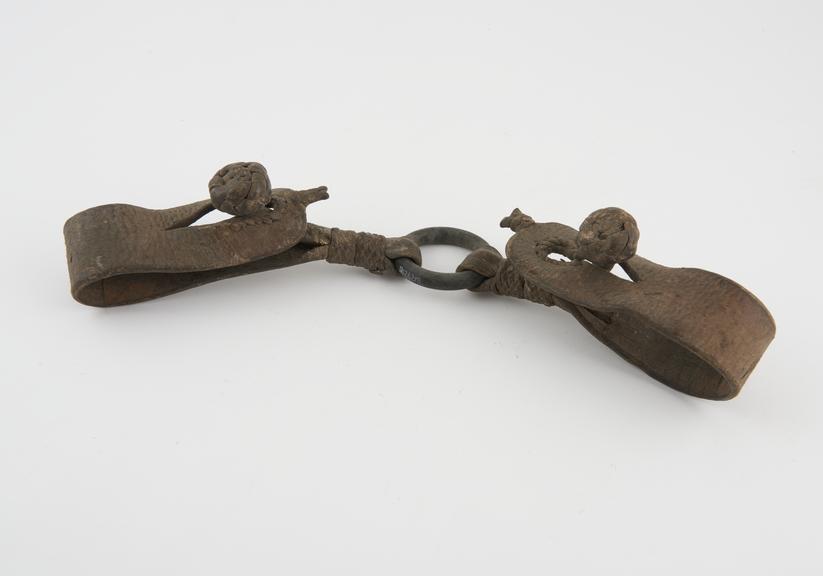 Handcuffs, composed of two hide cuffs joined by bronze ring