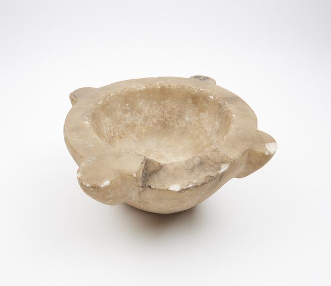 Cream marble bowl-shaped mortar with 4 lugs as rim