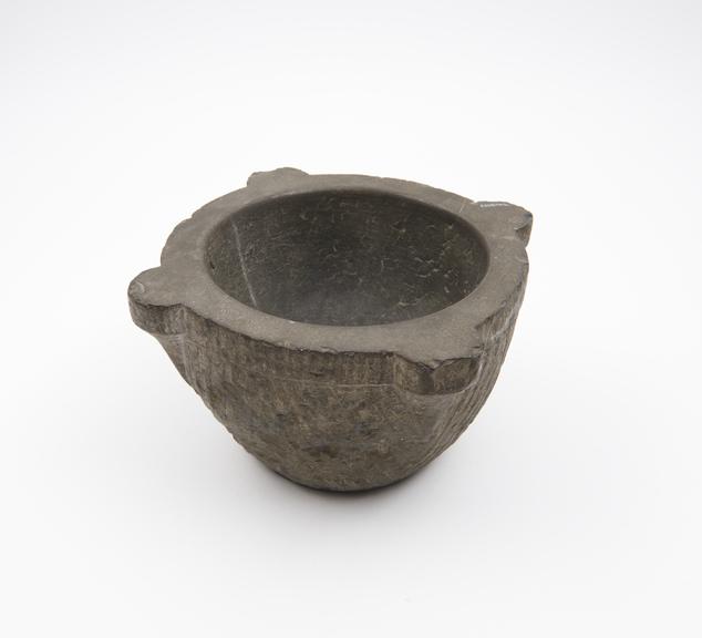 Small stone bowl-shaped mortar, with 4 lugs as rim