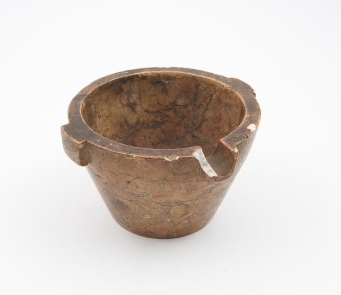 Small bucket-shaped marble mortar with two lugs and pouring