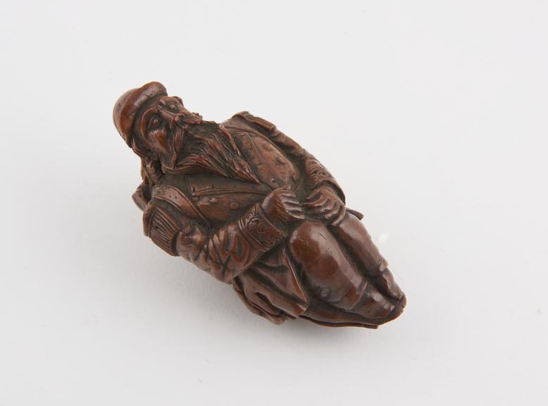 Wooden snuff box, in form of a seated soldier