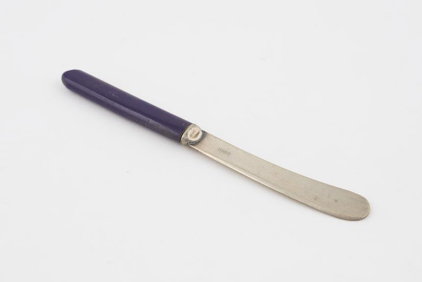 Butter knife with purple Parkesine handle; steel blades