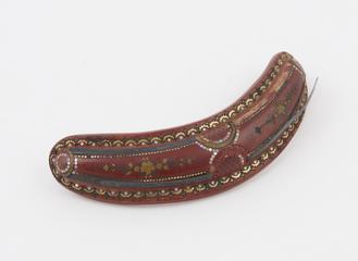 Crescentic hair slide of ochre-coloured Parkesine