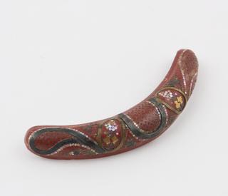 Crescentic hair slide of ochre-coloured Parkesine