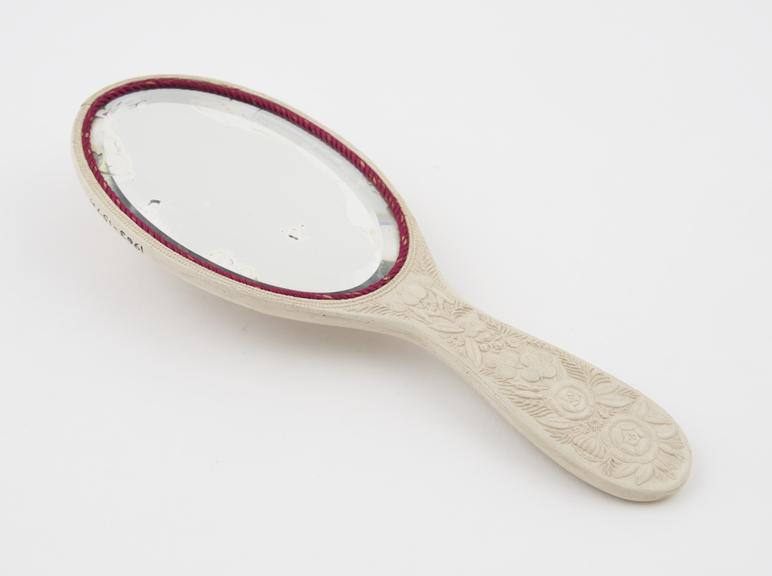 Small hand mirror in ivoride, manufactured by Daniel Spill