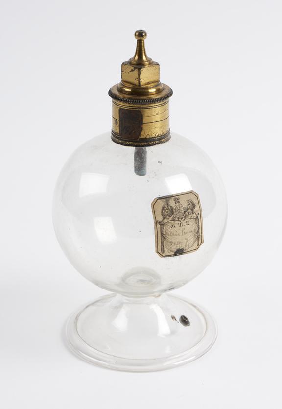 Glass globe, on a glass stand with a brass collar