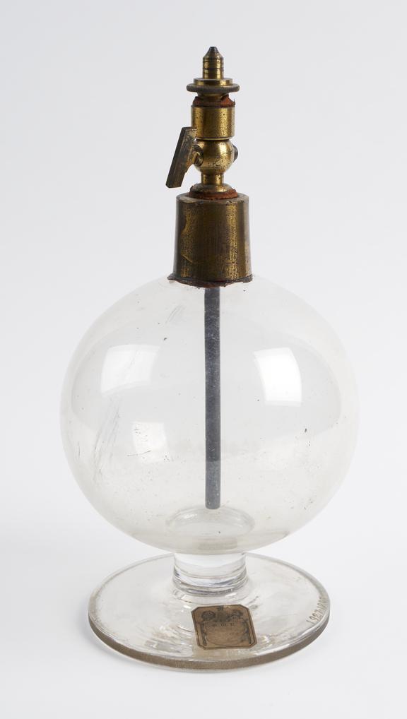 Glass globe with brass tap and cap containing brass tube