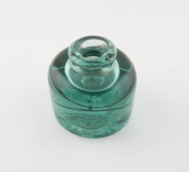 Cylindrical green glass inkwell with squat neck and thick rim