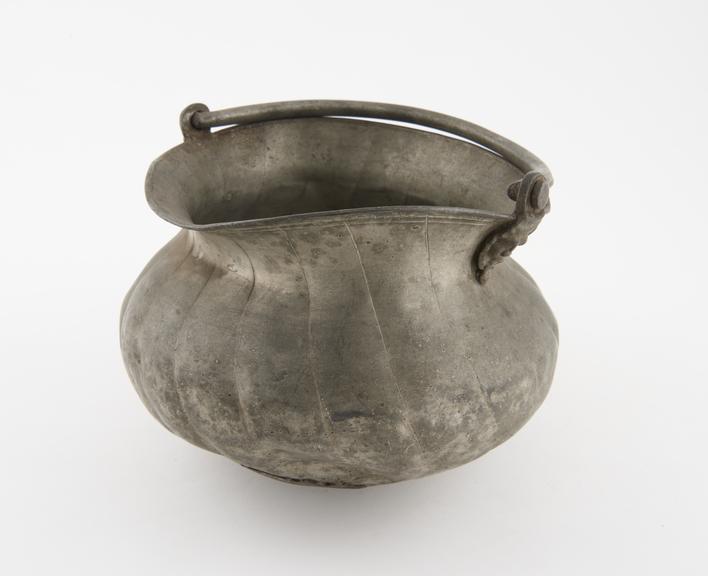 Small fluted pewter bucket with drop handle, dented