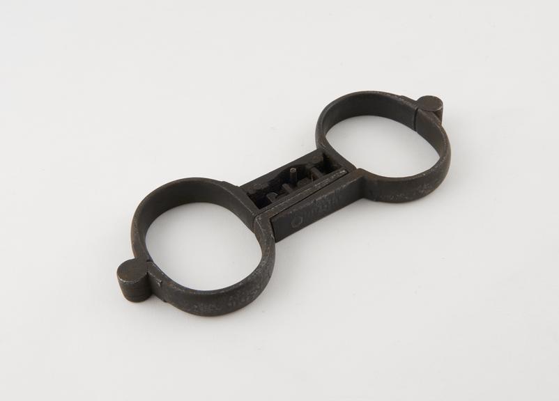 Handcuffs, iron, with integral lock, probably English