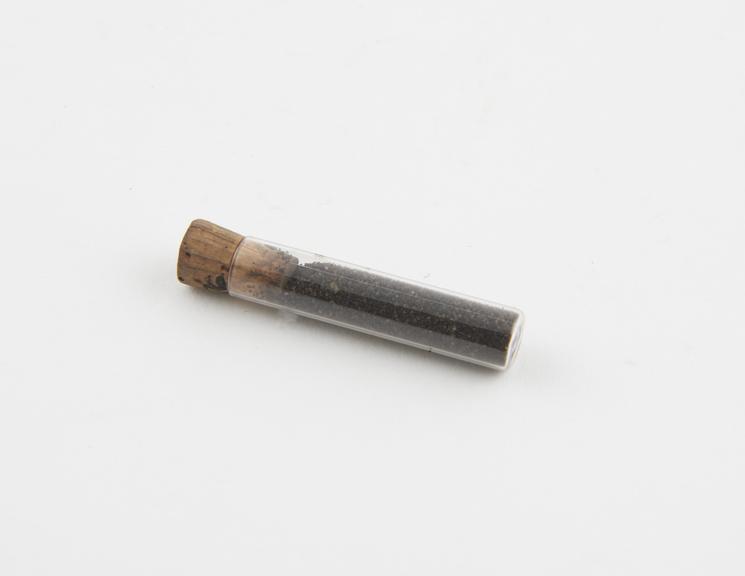 Glass test tube-like container with small cork stopper