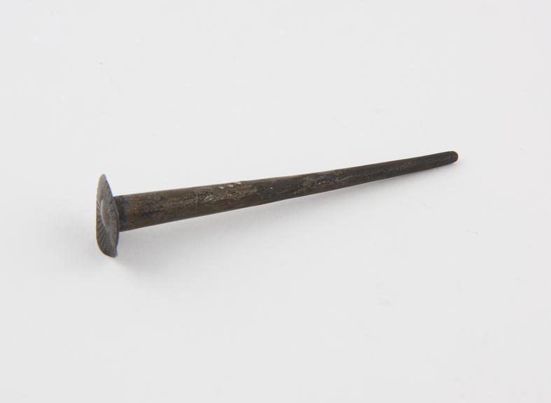 Pipe tamper in form of large nail, brass, English or French