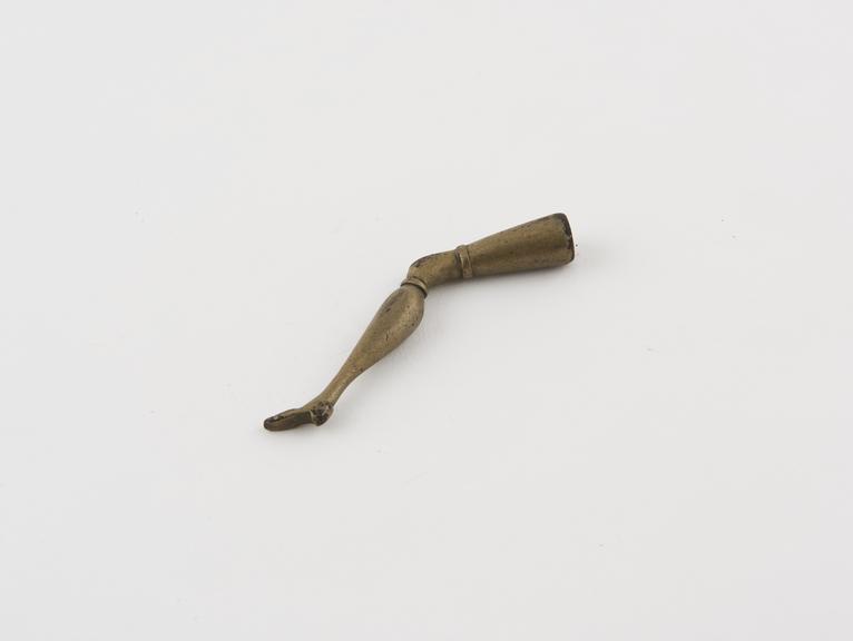 Pipe tamper, in form of human leg, brass, English or French