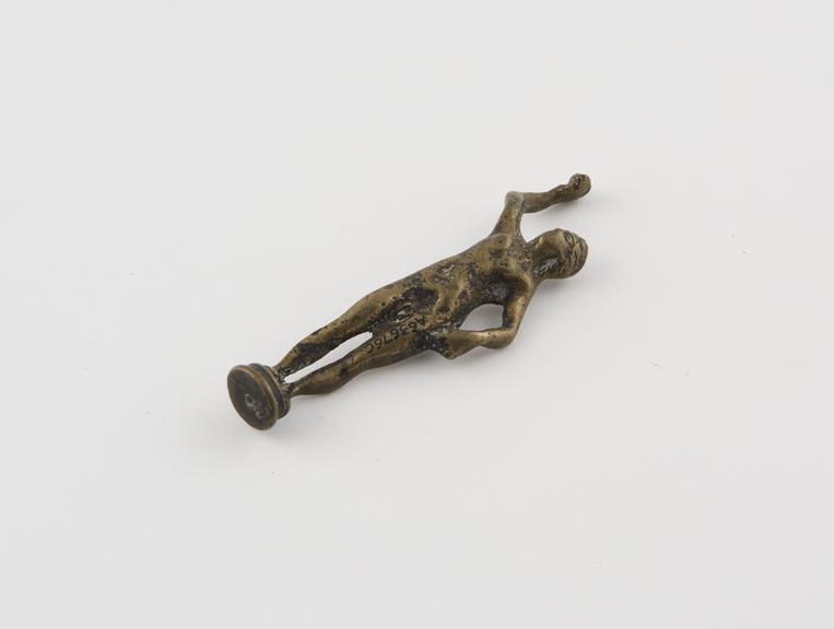 Pipe tamper, in form of nude female, brass, English or French