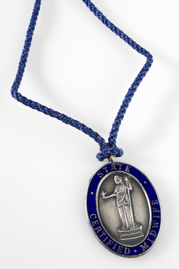 Metal pendent badge with blue silk cord for an S.C.M