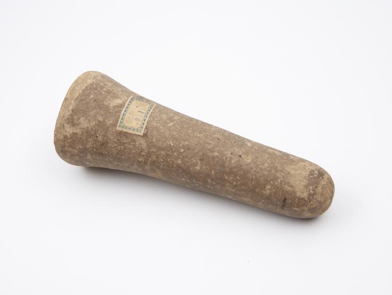 Elongated conical stone pounder with flat pounding end