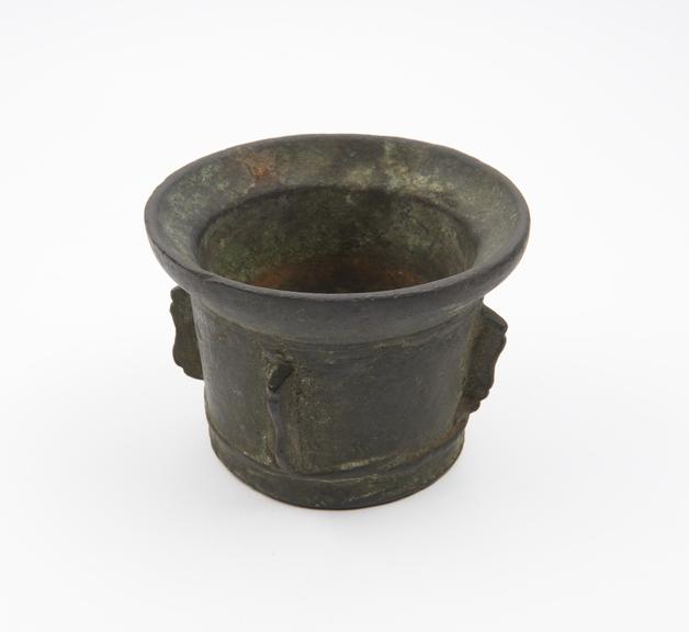 Small squat bronze mortar, everted rim, flat base