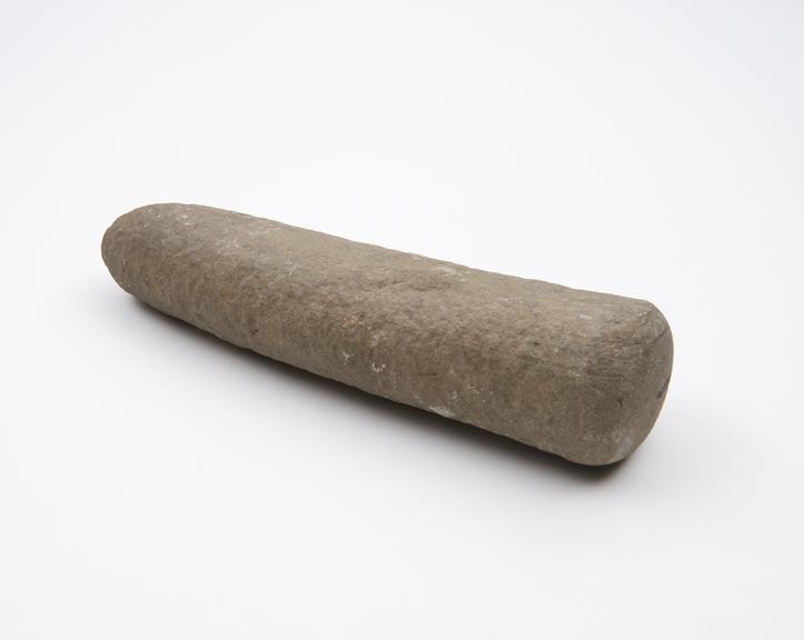 Long narrow stone pounder, slightly ovoid in cross-section