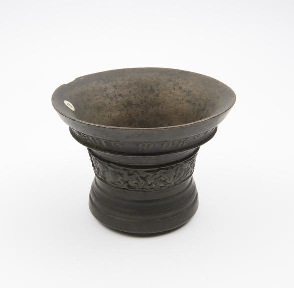 Bell shaped bronze mortar with narrow waist and wide flaring