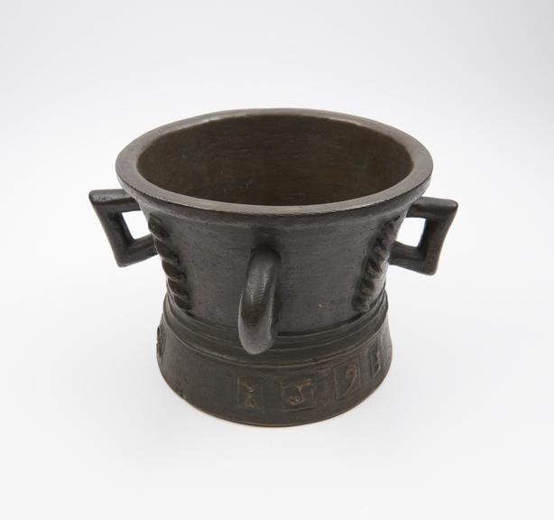 Large bronze 4-handled mortar, flared foot, twist decoration