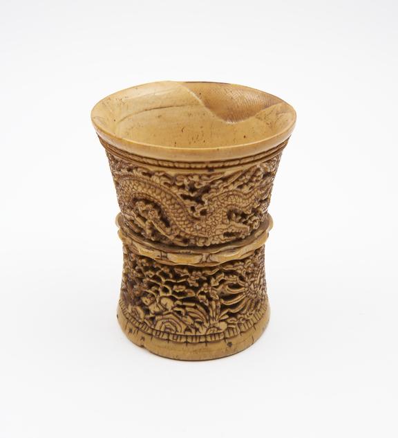 Carved ivory mortar depicting fire-breathing dragons in upper