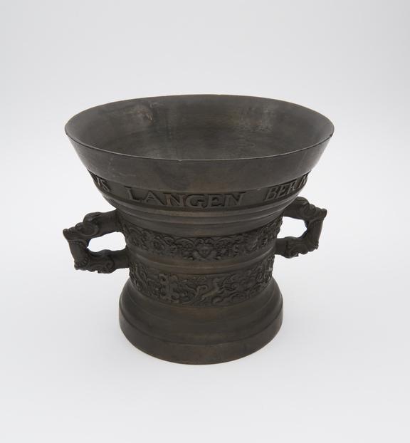 Very large bell-shaped bronze mortar, flared and inscribed rim